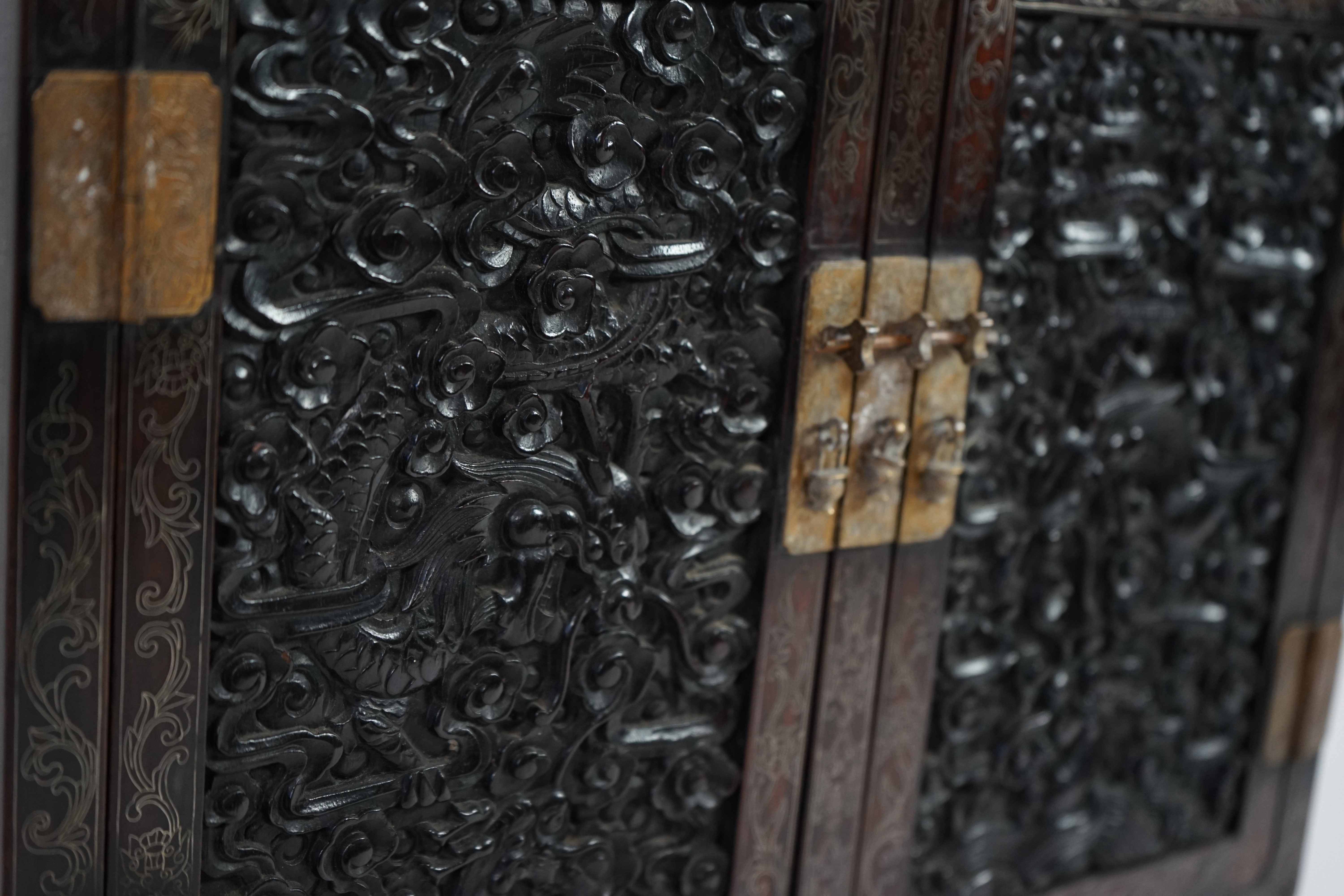 An important pair of Chinese carved zitan and silver wire inlaid ‘cloud and dragon’ curio cabinets and stands, duobaoge, probably Imperial, late Qing dynasty